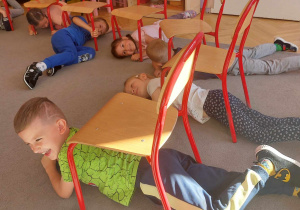 Dzieci ćwiczą spryt podczas zabaw pod krzesełkami